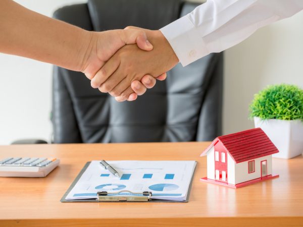 hands-agent-client-shaking-hands-after-signed-contract-buy-new-apartment